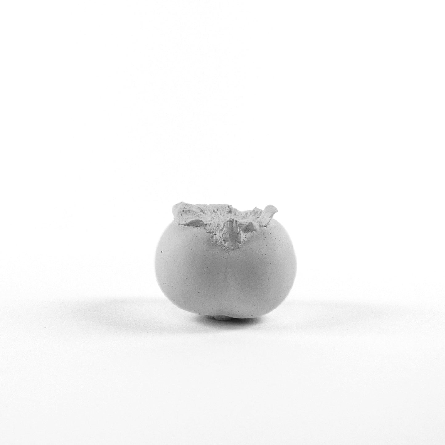 Persimmon made of plaster and fake fruit is all white