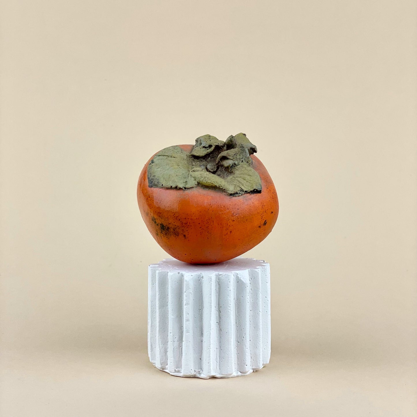 Persimmon sculpture made of plaster and hand painted