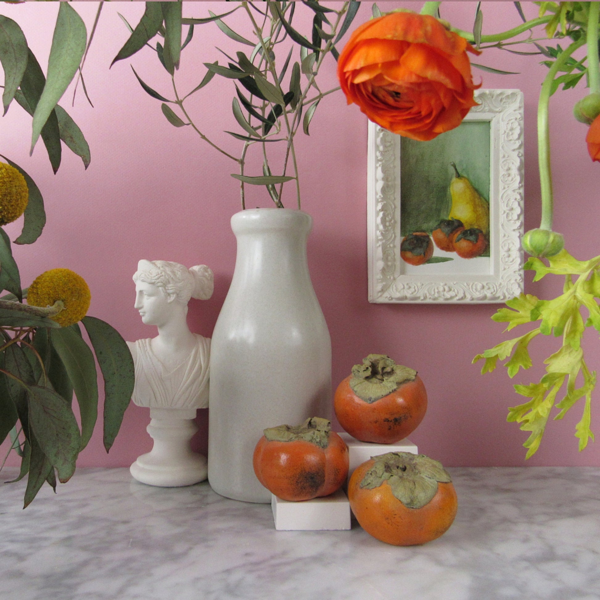 styling fake fruit and small apartment art 