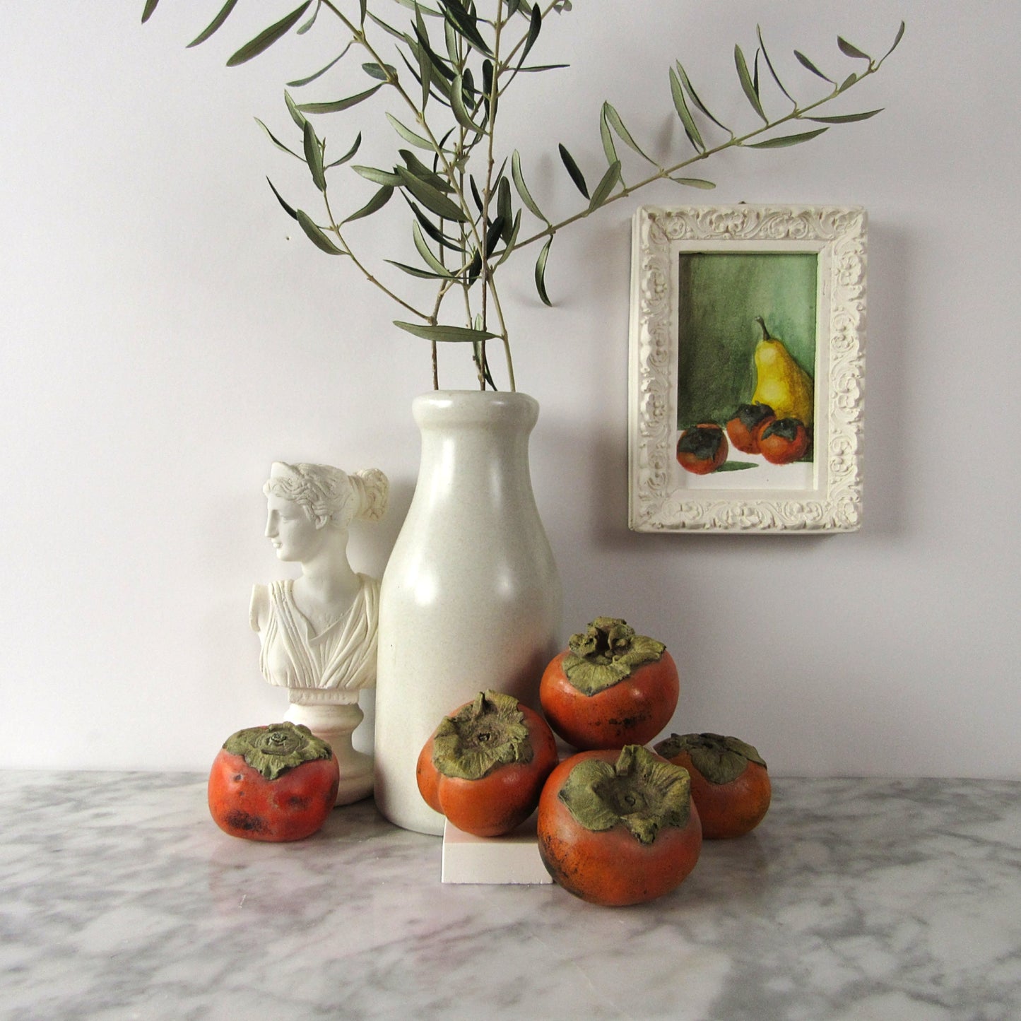 Persimmon sculpture made of plaster and hand painted with display ideas for fake fruit 