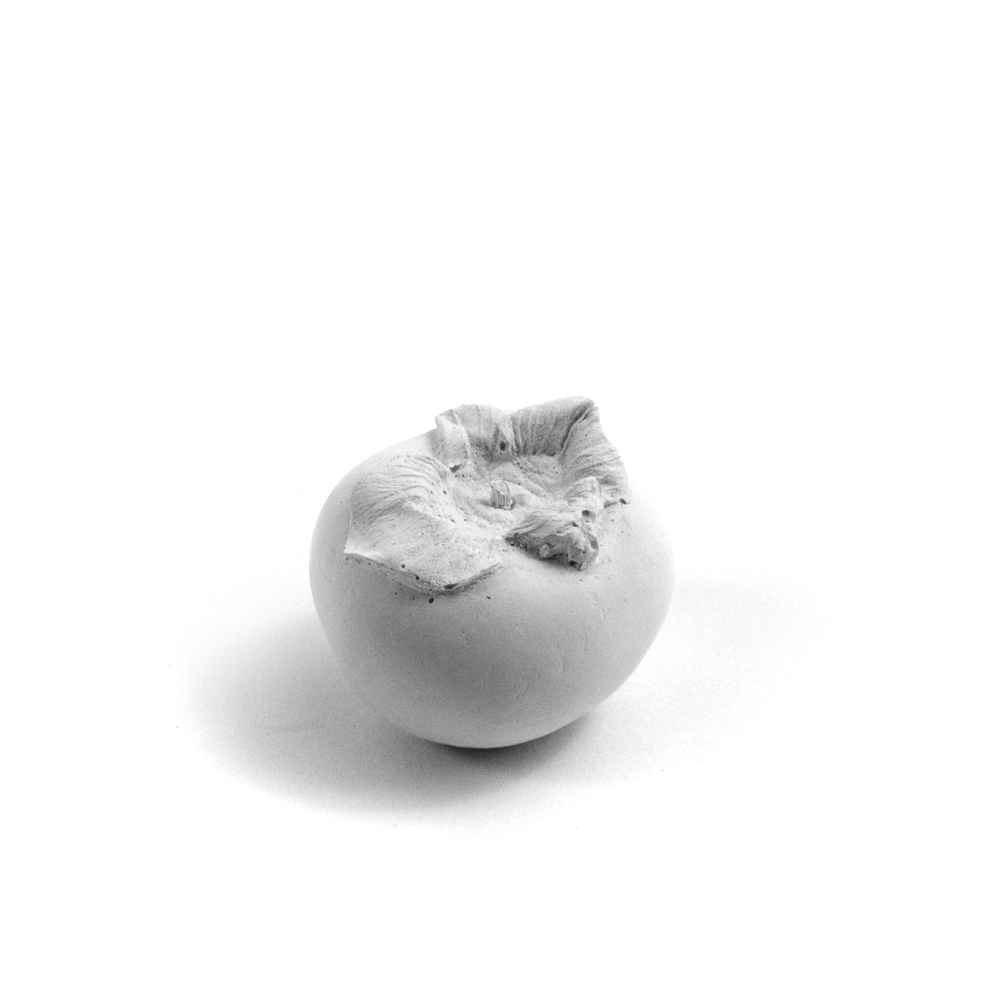 Persimmon made of plaster and fake fruit is all white